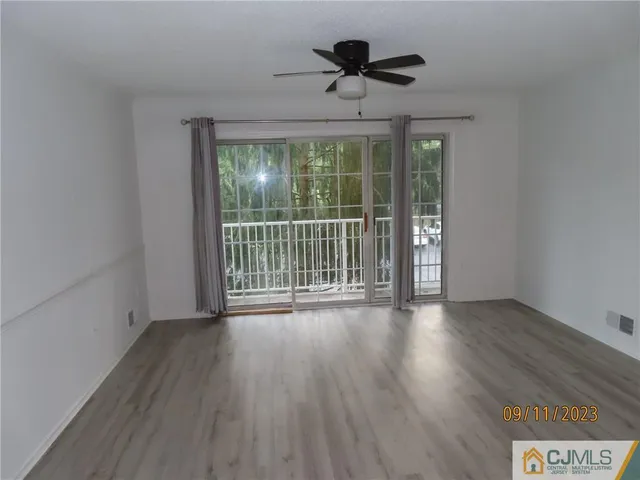 a view of a room with wooden floor and balcony