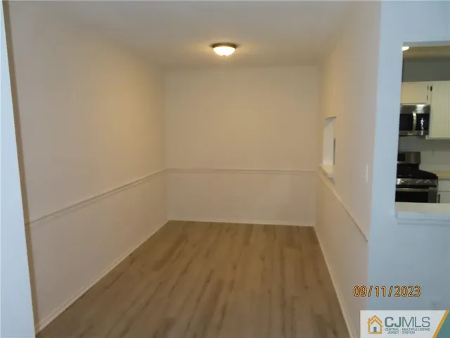 a view of a room with wooden floor