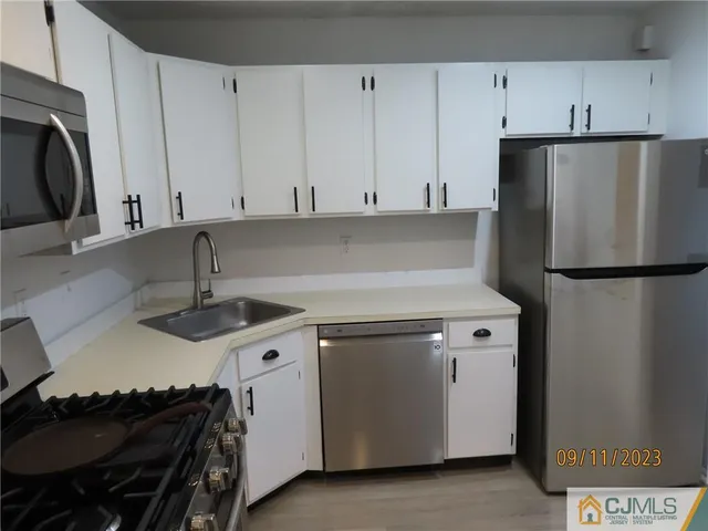a kitchen with a sink a stove and refrigerator