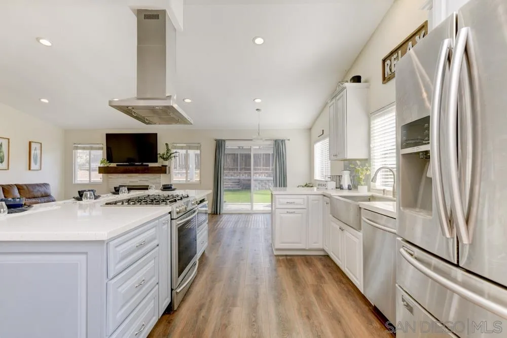 9317 Lake Country Drive Santee, CA 92071 - Photo 11 of 32 a kitchen with stainless steel appliances a stove refrigerator sink and microwave