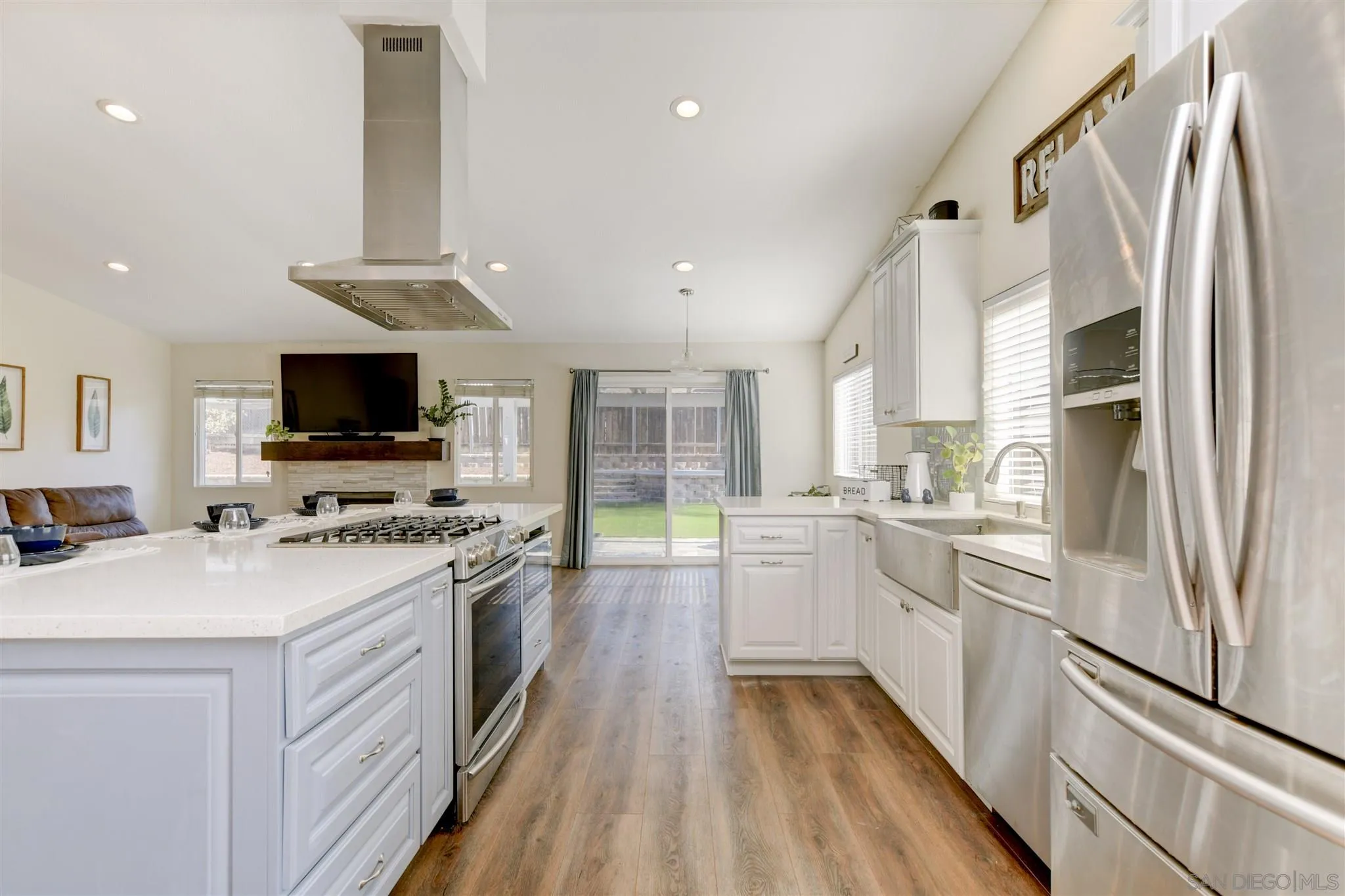 9317 Lake Country Drive Santee, CA 92071 - Photo 13 of 32 a kitchen with stainless steel appliances a stove top oven a sink a microwave a refrigerator and white cabinets