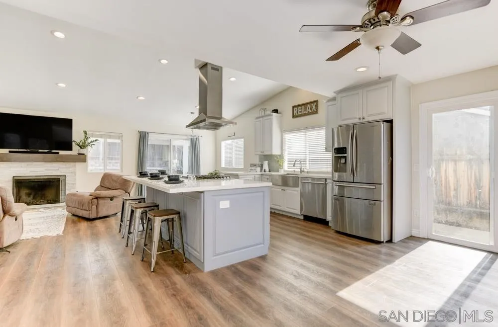 9317 Lake Country Drive Santee, CA 92071 - Photo 17 of 32 a kitchen with furniture a refrigerator and a fireplace