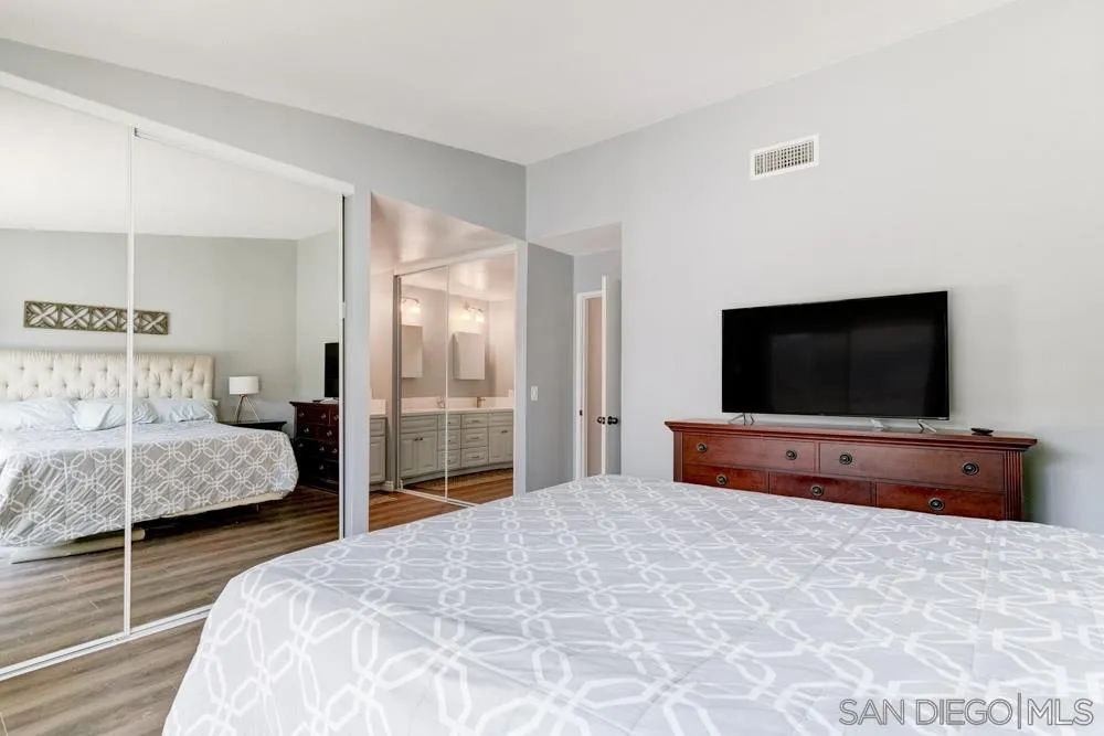 9317 Lake Country Drive Santee, CA 92071 - Photo 22 of 32 a bedroom with a bed and a flat screen tv