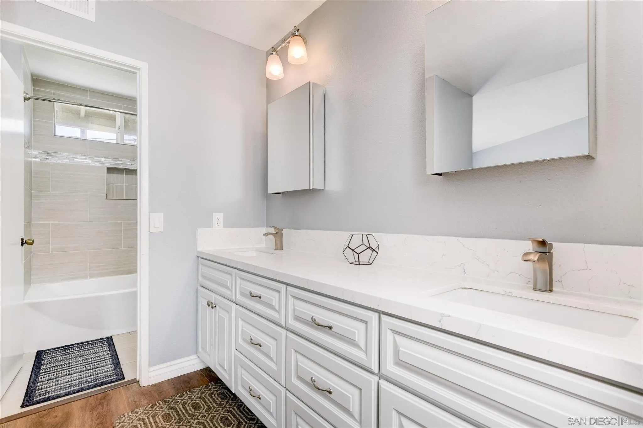 9317 Lake Country Drive Santee, CA 92071 - Photo 23 of 32 a bathroom with a sink and a mirror