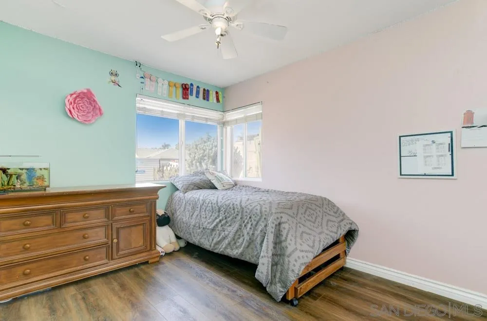 9317 Lake Country Drive Santee, CA 92071 - Photo 24 of 32 a bedroom with a bed and a chandelier