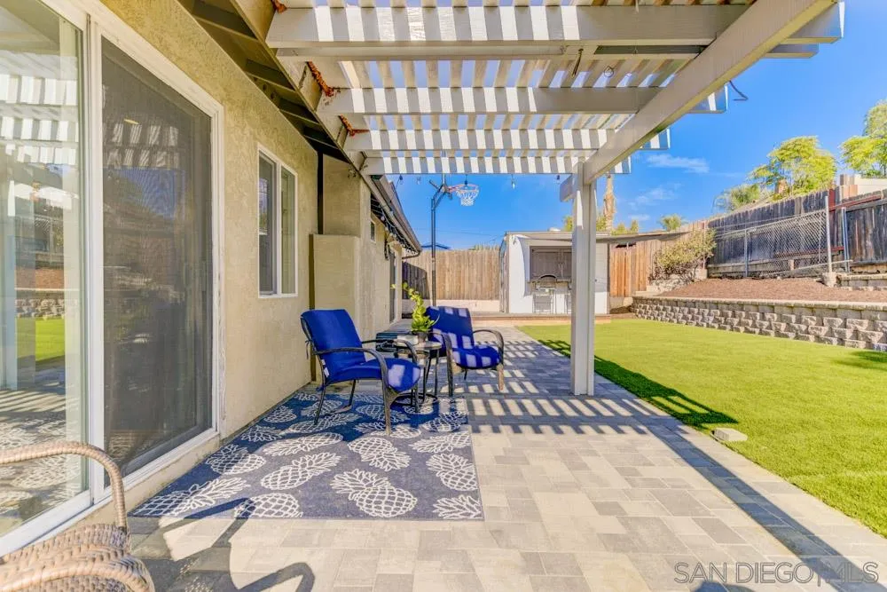 9317 Lake Country Drive Santee, CA 92071 - Photo 30 of 32 a view of a chairs and table in the patio with a backyard