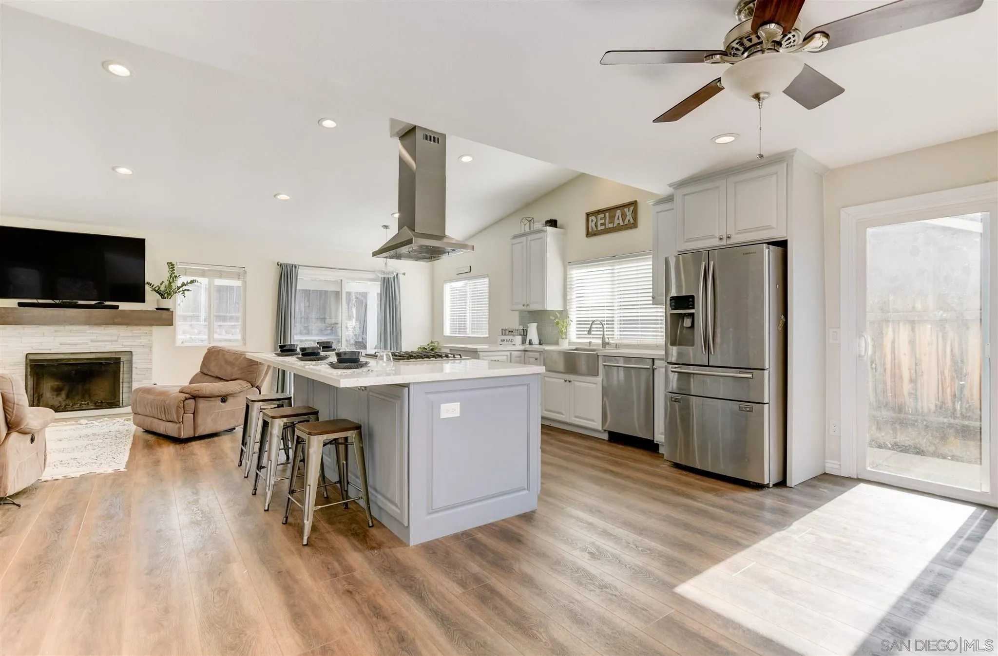 9317 Lake Country Drive Santee, CA 92071 - Photo 3 of 32 a kitchen with furniture a refrigerator and a fireplace