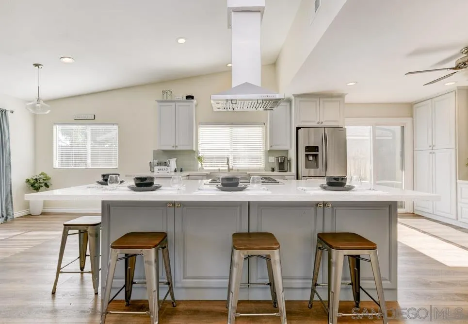 9317 Lake Country Drive Santee, CA 92071 - Photo 4 of 32 a kitchen with a table chairs sink and cabinets