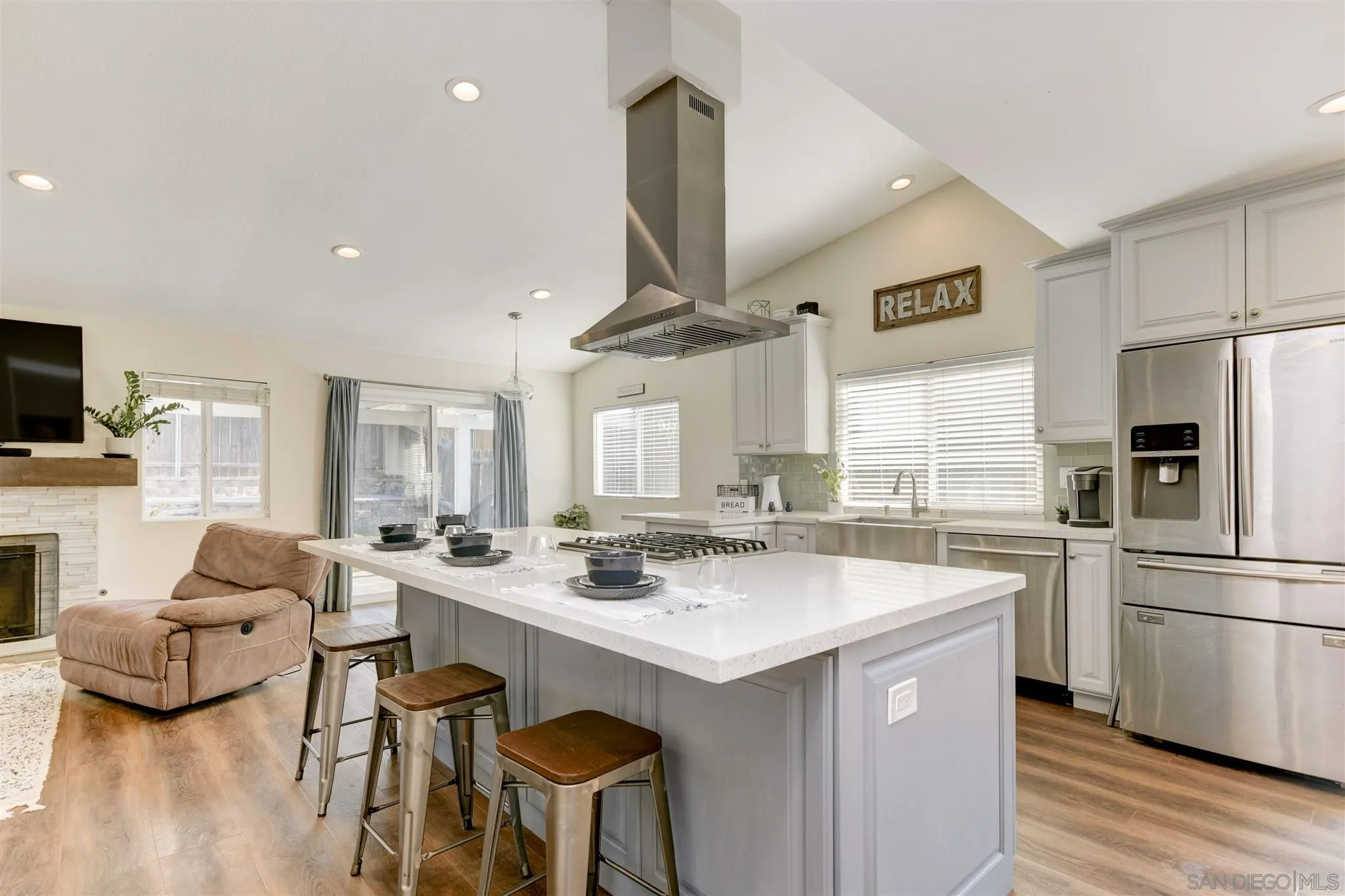 9317 Lake Country Drive Santee, CA 92071 - Photo 10 of 32 a kitchen with stainless steel appliances a sink a stove a refrigerator cabinets and a dining table