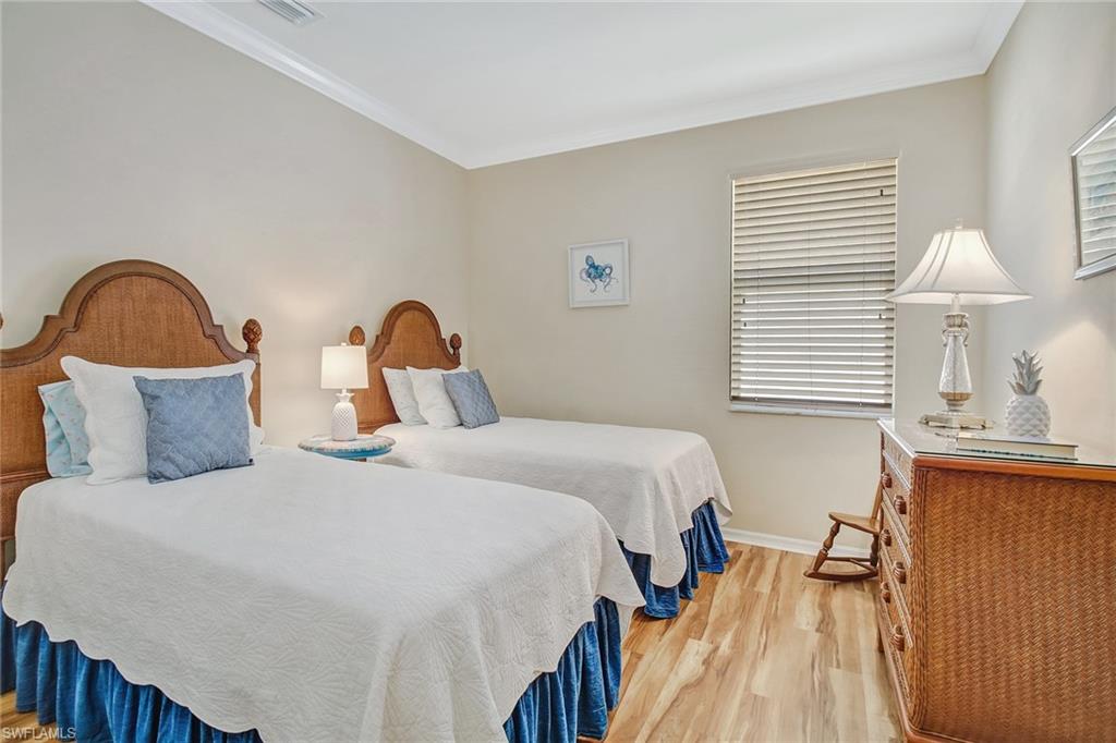 5706 Lago Villaggio Way Naples, FL 34104 - Photo 11 of 32 a bedroom with bed and a window