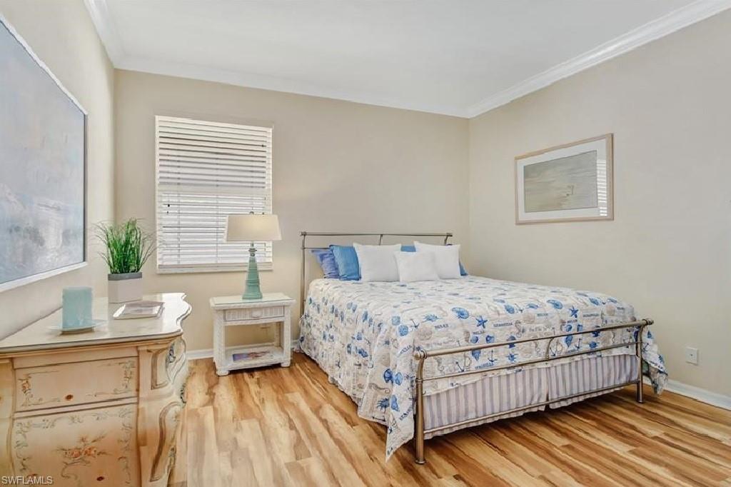 5706 Lago Villaggio Way Naples, FL 34104 - Photo 12 of 32 a bedroom with a bed and windows