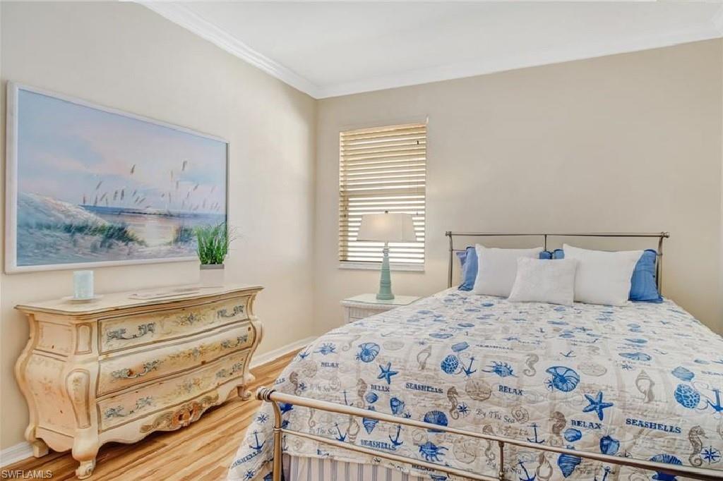 5706 Lago Villaggio Way Naples, FL 34104 - Photo 14 of 32 a bedroom with a bed and a window