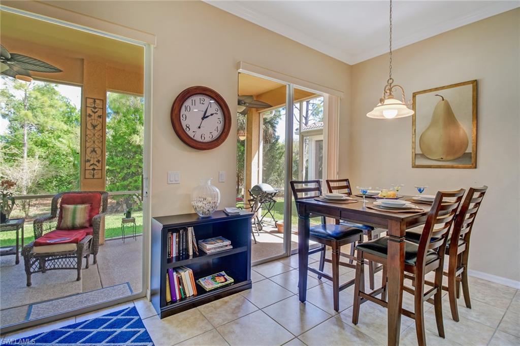 5706 Lago Villaggio Way Naples, FL 34104 - Photo 17 of 32 a view of a dining room with furniture window and wooden floor