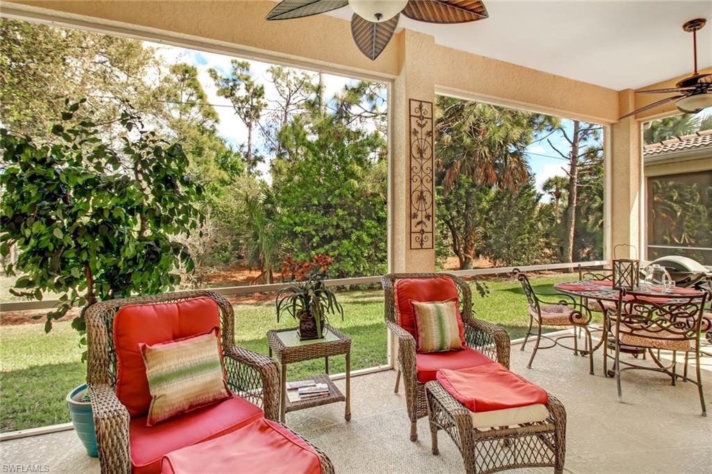 5706 Lago Villaggio Way Naples, FL 34104 - Photo 19 of 32 a balcony with furniture and a view of the back yard