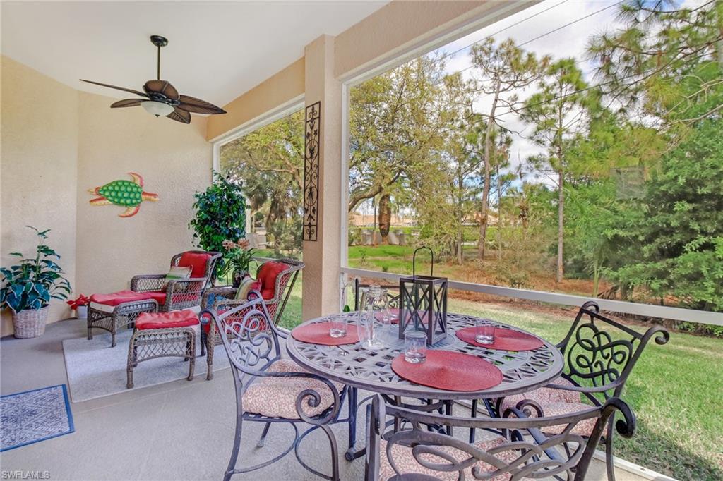 5706 Lago Villaggio Way Naples, FL 34104 - Photo 20 of 32 a dining room with furniture and wooden floor