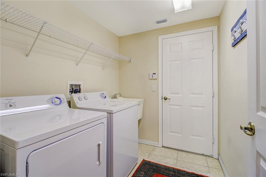 5706 Lago Villaggio Way Naples, FL 34104 - Photo 23 of 32 a utility room with dryer and washer