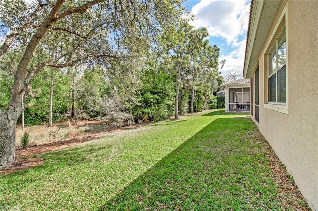 5706 Lago Villaggio Way Naples, FL 34104 - Photo 24 of 32 a view of a house with a yard