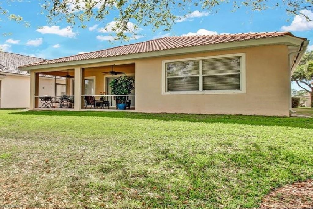 5706 Lago Villaggio Way Naples, FL 34104 - Photo 25 of 32 front view of a house with a yard