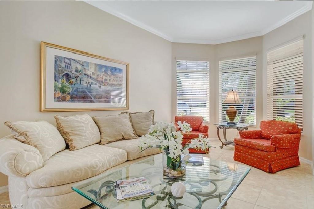 5706 Lago Villaggio Way Naples, FL 34104 - Photo 5 of 32 a living room with furniture and a large window