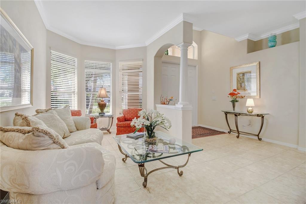 5706 Lago Villaggio Way Naples, FL 34104 - Photo 6 of 32 a living room with furniture and a large window