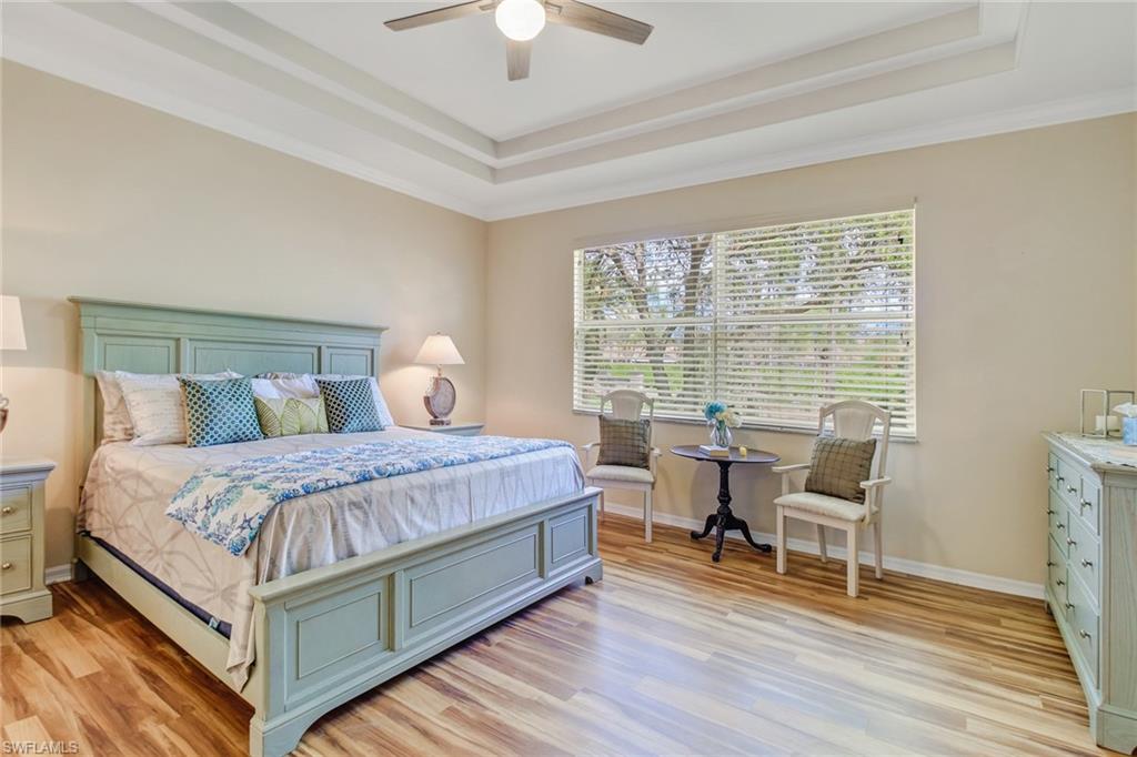5706 Lago Villaggio Way Naples, FL 34104 - Photo 7 of 32 a bedroom with a bed and wooden floor