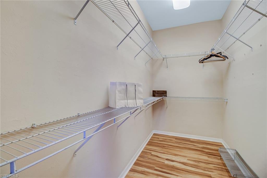 5706 Lago Villaggio Way Naples, FL 34104 - Photo 10 of 32 a view of a room with racks on the wall