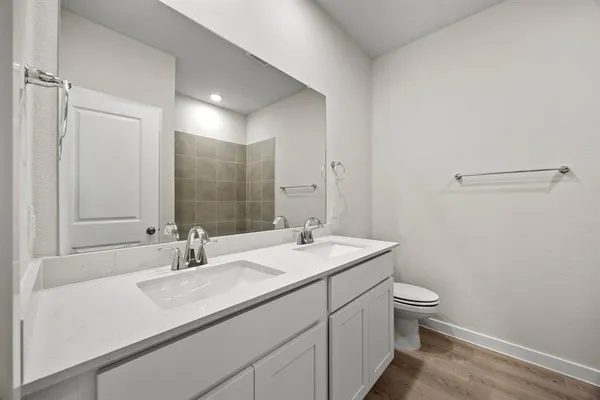 a bathroom with a sink toilet and mirror