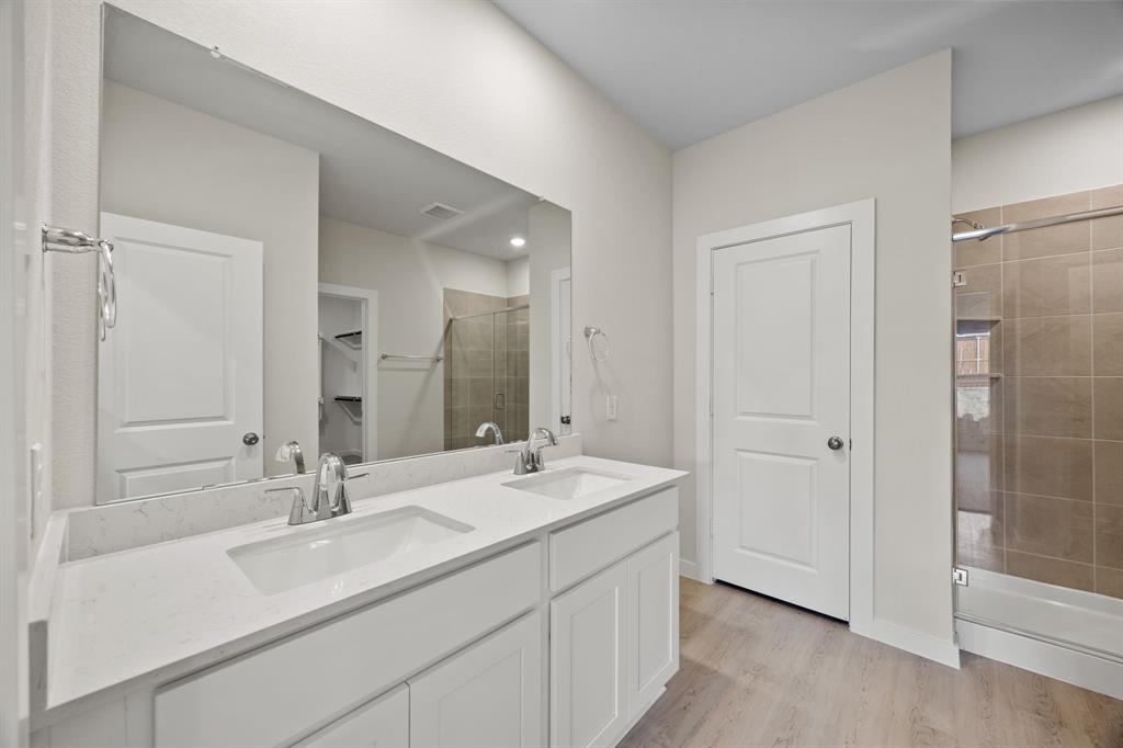 731 Carson Drive Forney, TX 75126 - Photo 7 of 31 a bathroom with a double vanity sink mirror and shower