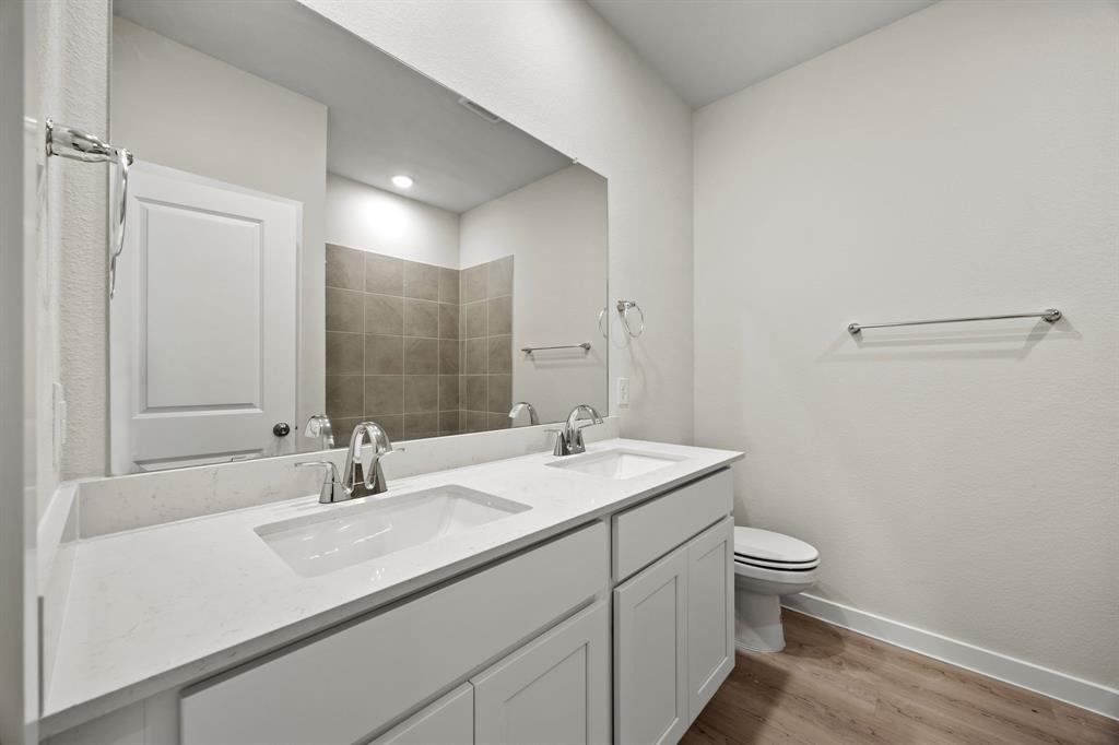 731 Carson Drive Forney, TX 75126 - Photo 10 of 31 a bathroom with a sink toilet and mirror