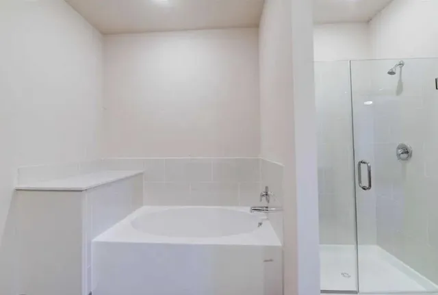 an empty room with wooden floor cabinet and windows