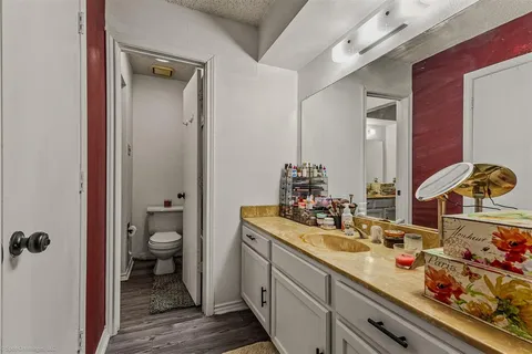 a bathroom with a double vanity sink toilet and shower