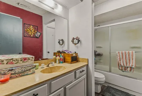 a bathroom with a sink toilet tub and shower