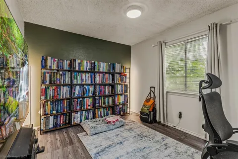 a view of a workspace with furniture and a book shelf