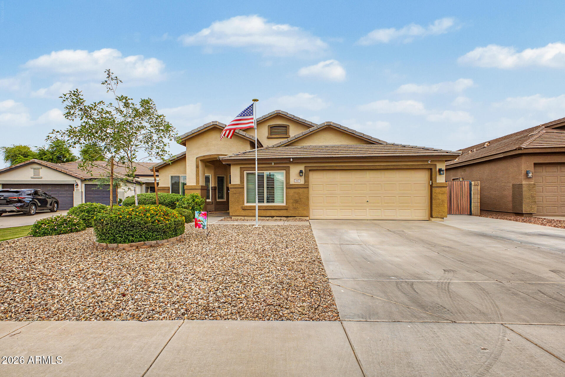 3425 South Loback Lane Gilbert, AZ 85297 - Photo 2 of 52 a front view of a house with garden