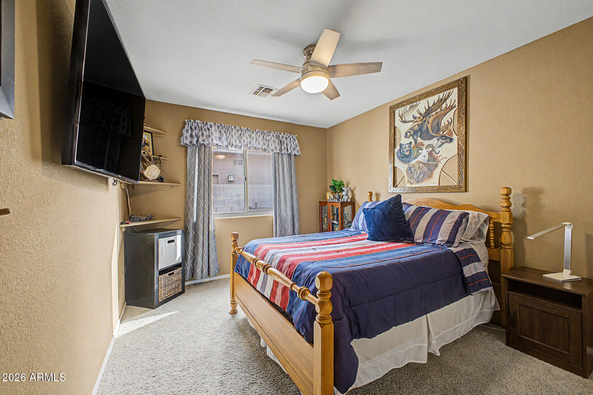 3425 South Loback Lane Gilbert, AZ 85297 - Photo 25 of 52 a bedroom with a bed and a flat screen tv