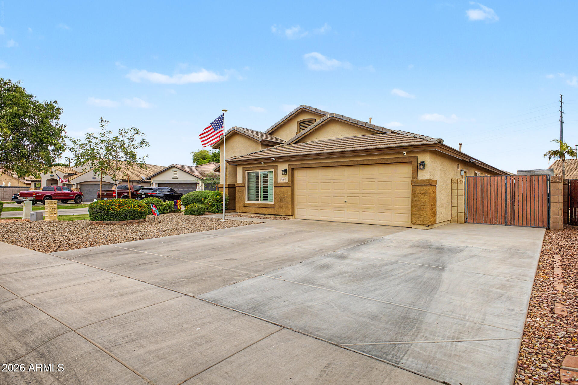 3425 South Loback Lane Gilbert, AZ 85297 - Photo 3 of 52 a front view of a house with a yard and garage