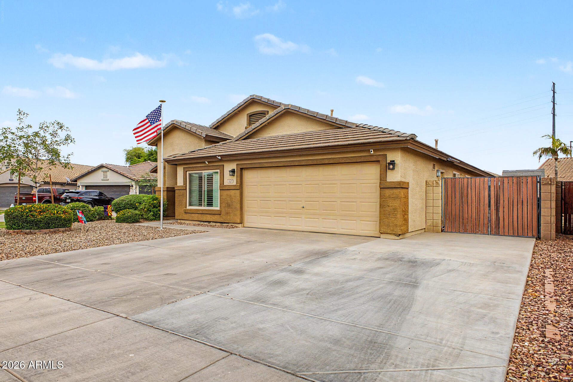 3425 South Loback Lane Gilbert, AZ 85297 - Photo 4 of 52 a front view of a house with a yard and garage