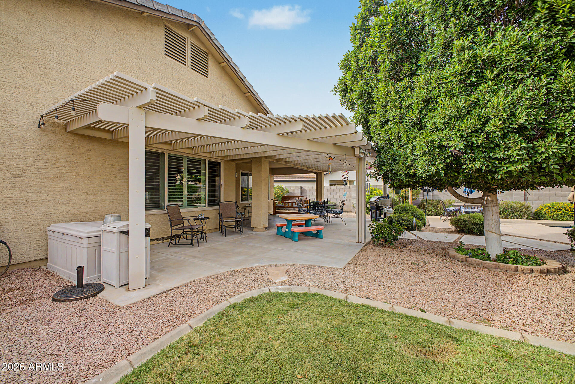 3425 South Loback Lane Gilbert, AZ 85297 - Photo 42 of 52 a view of a patio with table and chairs potted plants and a barbeque