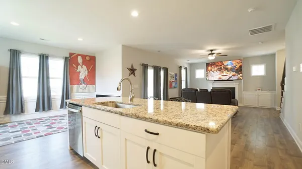 a kitchen with granite countertop a stove and a sink