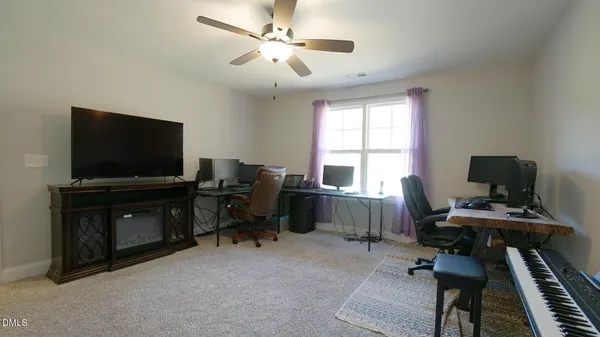 a view of a workspace with furniture and a window