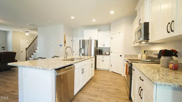a large kitchen with stainless steel appliances lots of counter space sink and cabinets