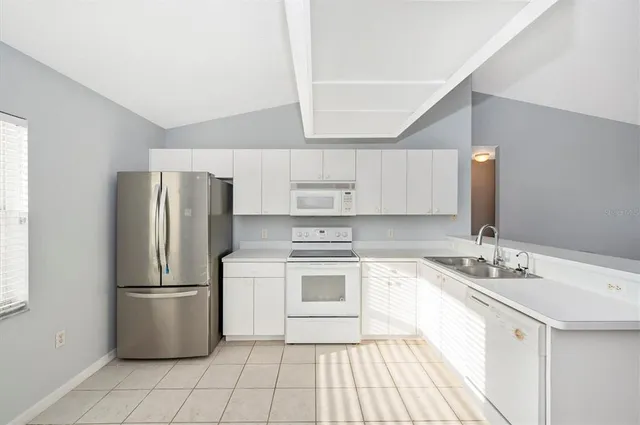 a kitchen with a sink stainless steel appliances and cabinets