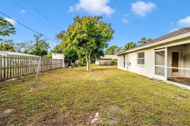 a view of a big house with wooden fence