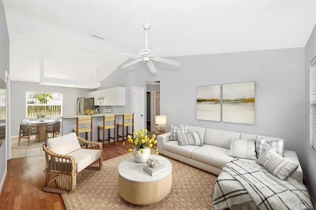 a living room with furniture and a chandelier