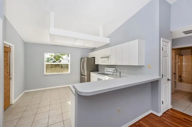 a room with a sink cabinets and wooden floor