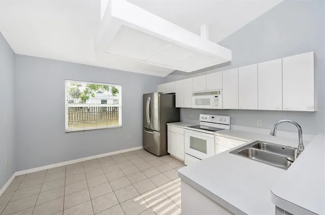 a kitchen with a stove a sink and a microwave