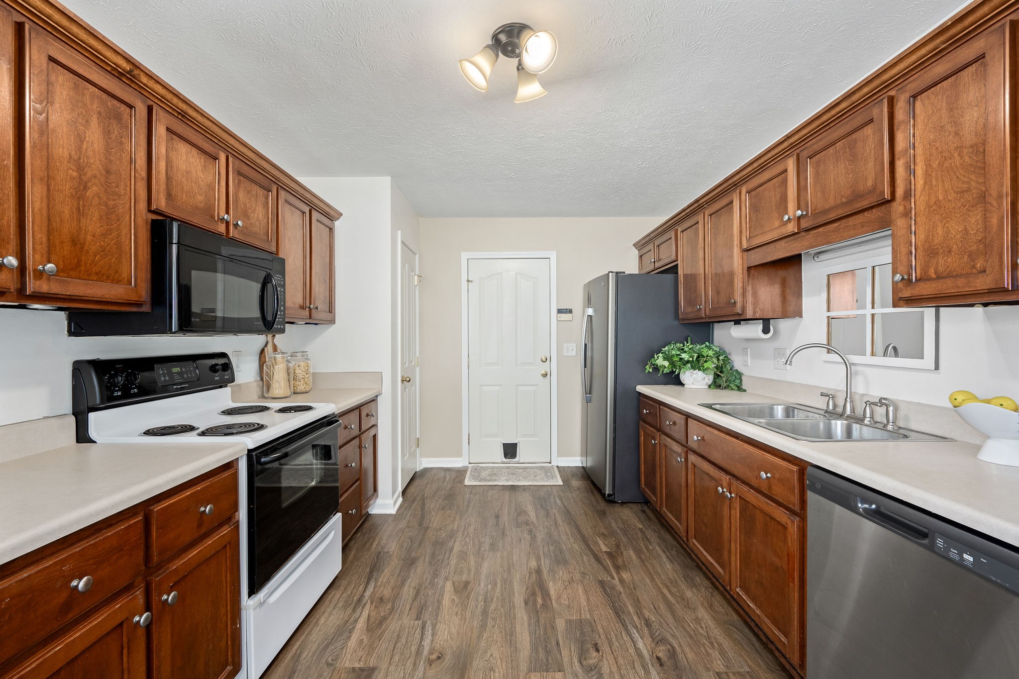 3620 Stevens Bend Drive Murfreesboro, TN 37127 - Photo 8 of 31 a kitchen with stainless steel appliances a stove sink microwave and cabinets