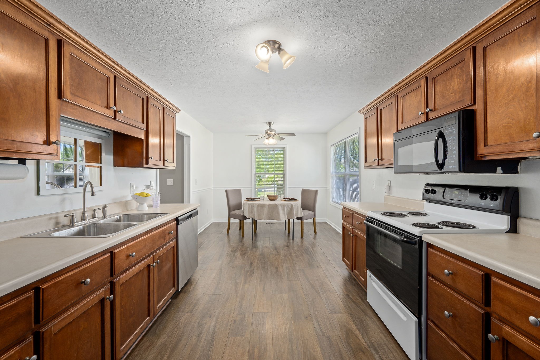 3620 Stevens Bend Drive Murfreesboro, TN 37127 - Photo 9 of 31 a kitchen with stainless steel appliances a stove sink microwave and cabinets