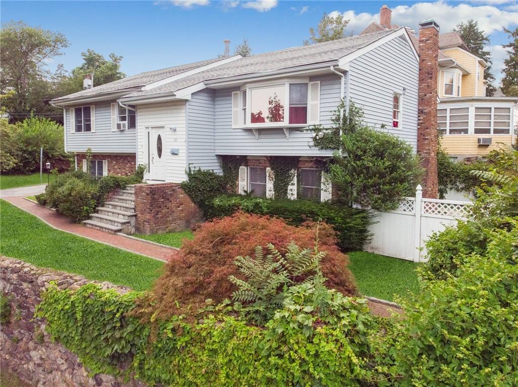 165 Sutton Manor Road New Rochelle, NY 10801 - Photo 1 of 1 a front view of a house with garden and porch