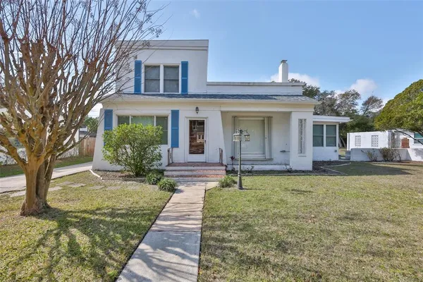 a front view of a house with garden
